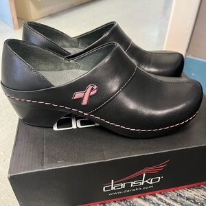 Brand New in box Dansko clogs. Black with pink ribbon.